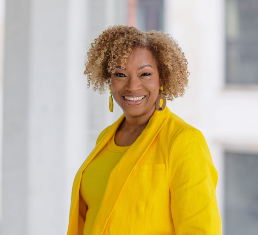 Black woman, joyful, natural hair, yellow